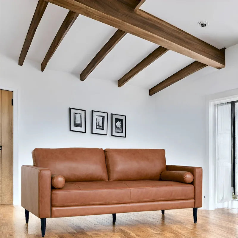 Divano moderno in vera pelle con gambe in legno e cuscino a rullo aggiuntivo